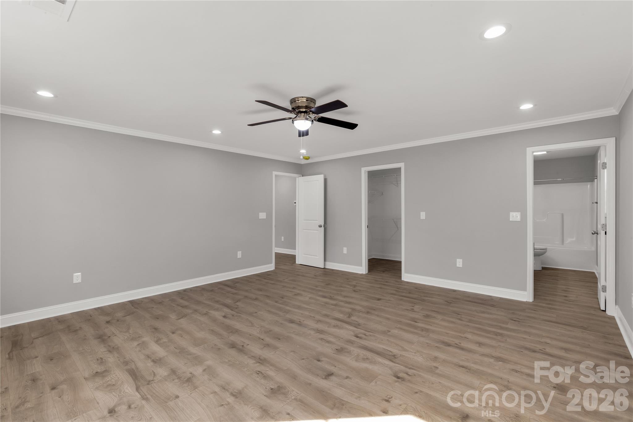 2166 Reeves Road Lancaster, SC 29720 - Photo 18 of 37 wooden floor in an empty room with a ceiling fan
