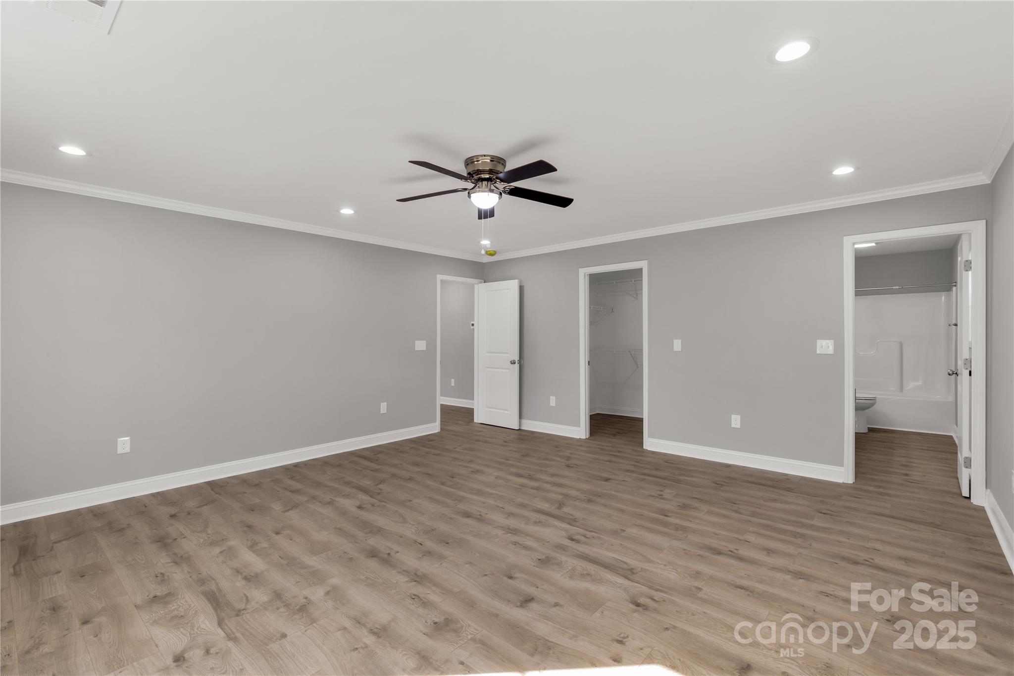 2166 Reeves Road Lancaster, SC 29720 - Photo 19 of 32 wooden floor in an empty room with a ceiling fan