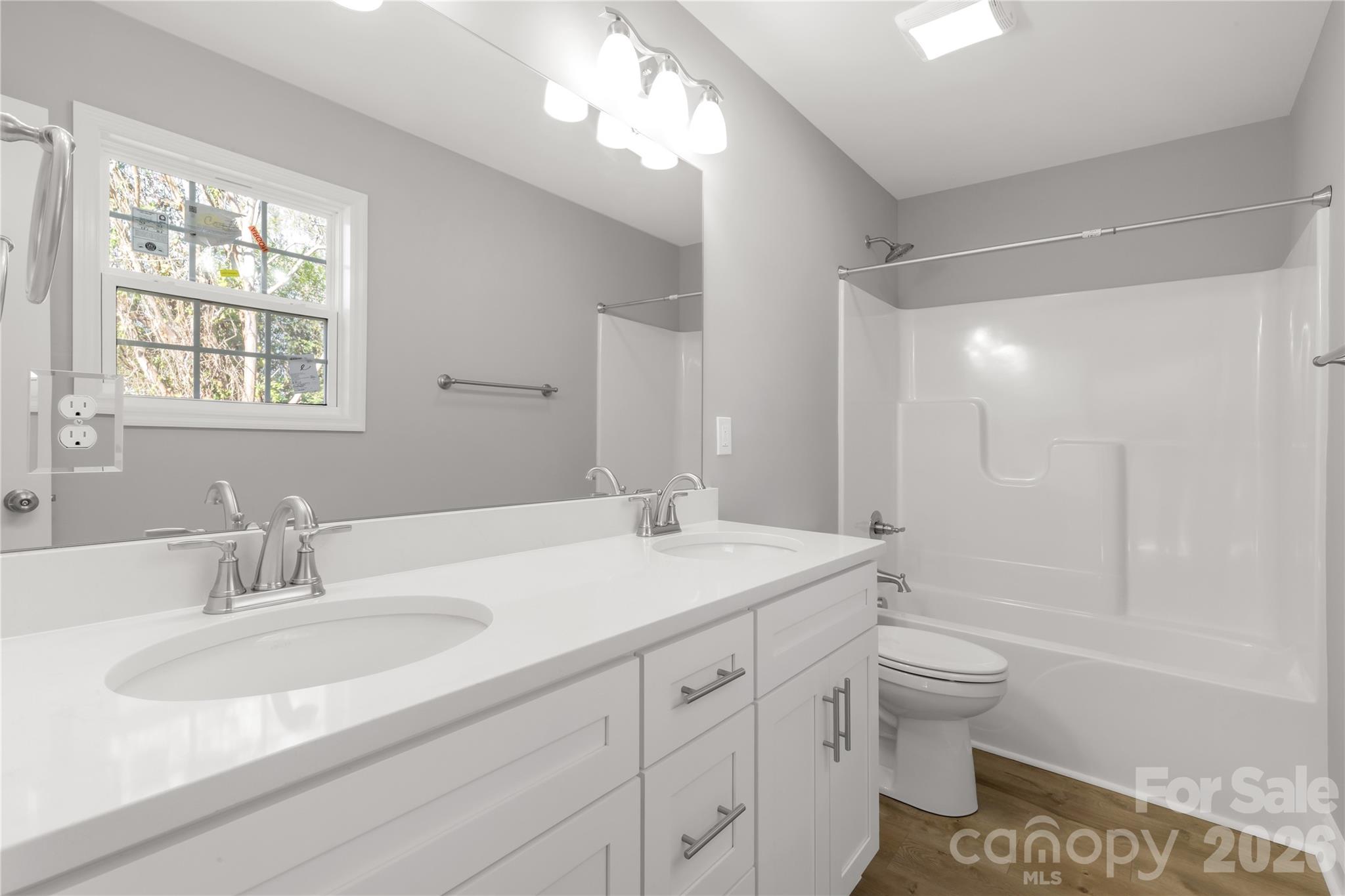 2166 Reeves Road Lancaster, SC 29720 - Photo 20 of 37 a bathroom with a sink double vanity granite toilet tub and shower