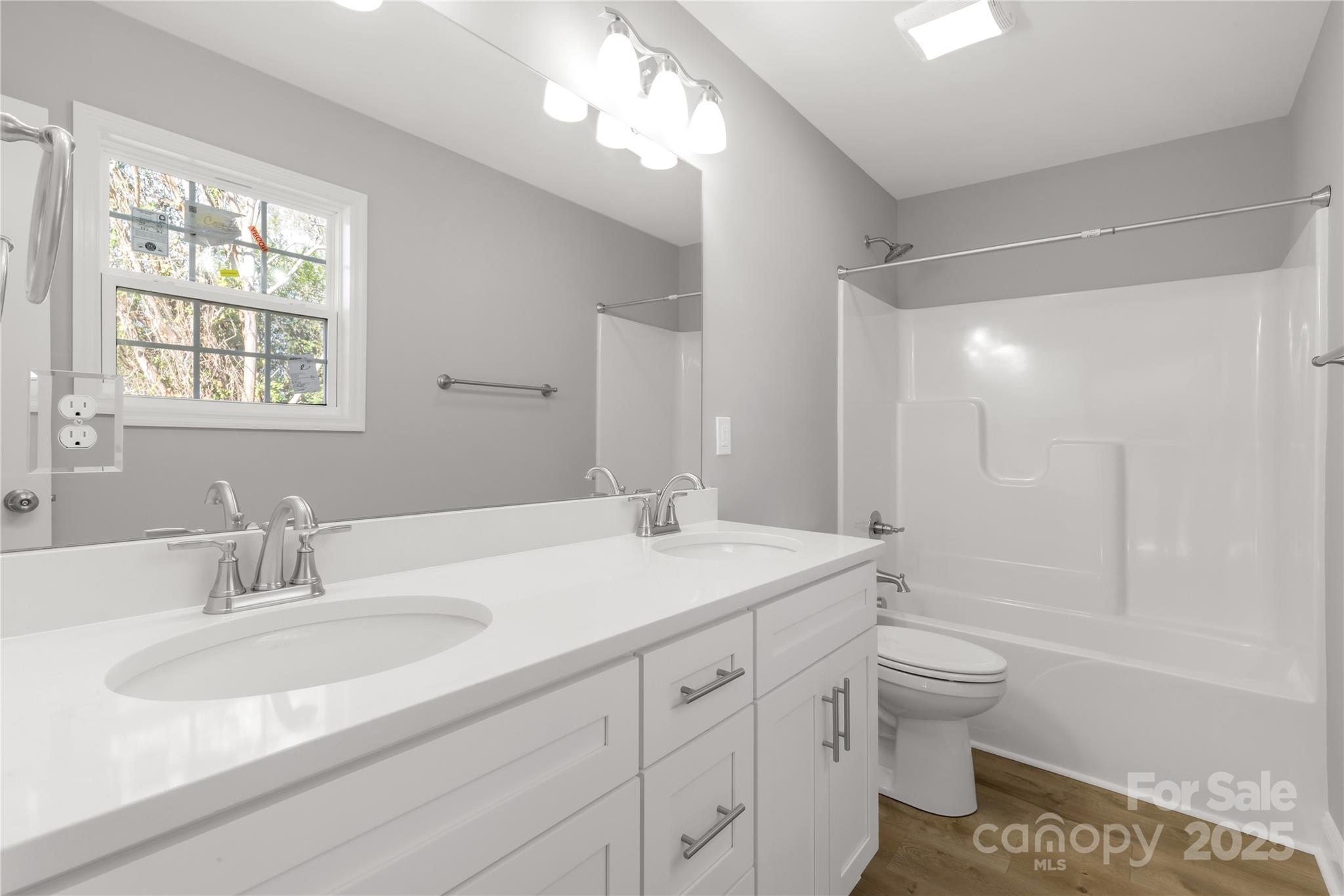 2166 Reeves Road Lancaster, SC 29720 - Photo 21 of 32 a bathroom with a sink double vanity granite toilet tub and shower