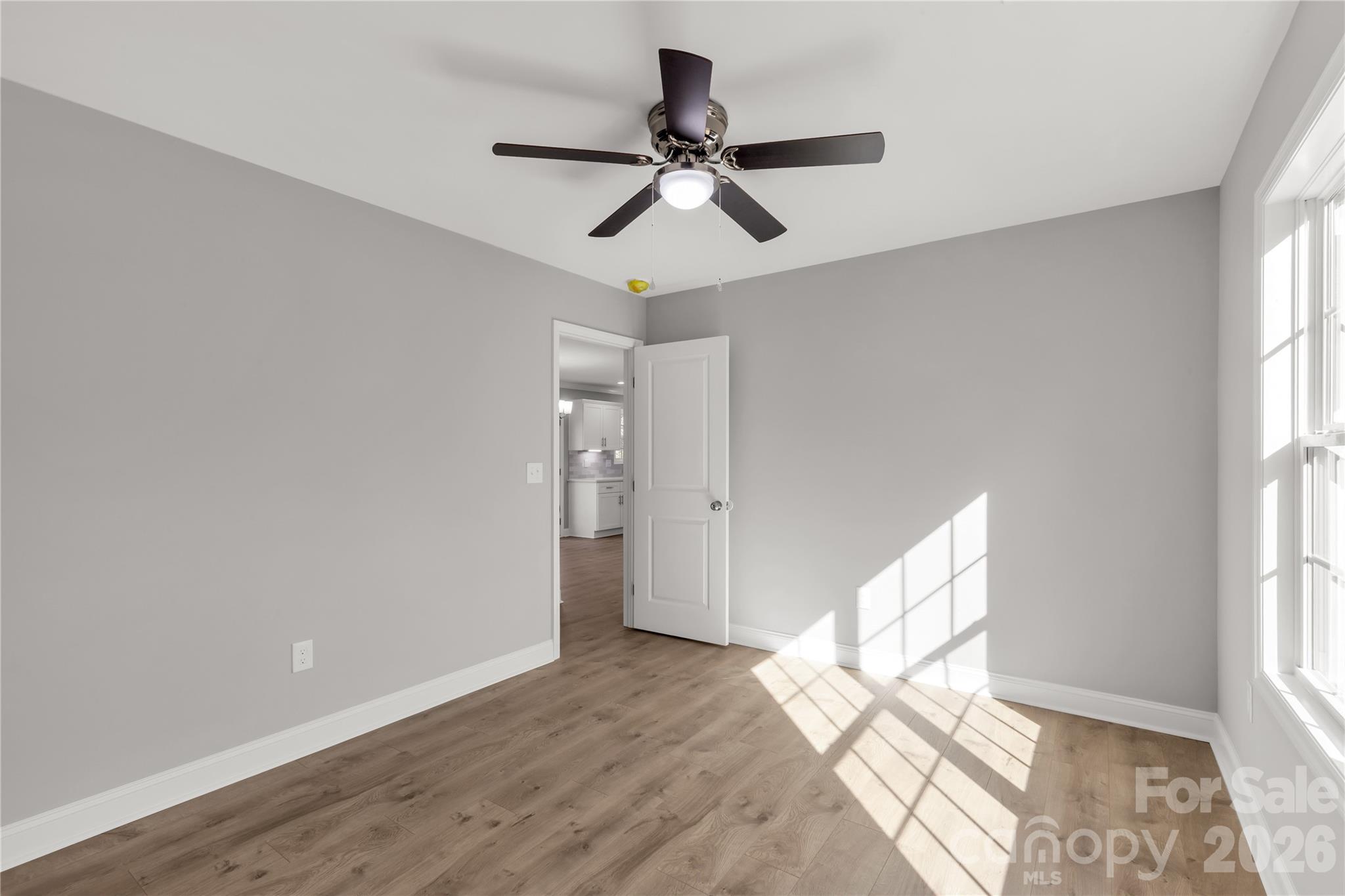 2166 Reeves Road Lancaster, SC 29720 - Photo 22 of 37 a view of empty room with wooden floor and fan