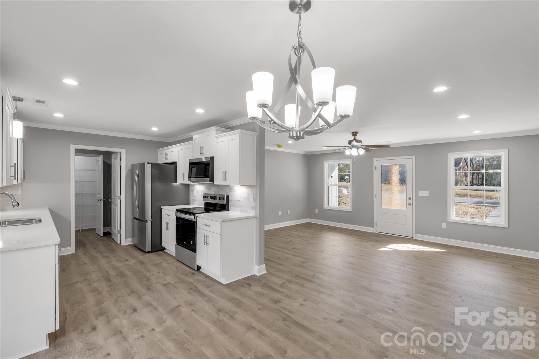 2166 Reeves Road Lancaster, SC 29720 - Photo 7 of 37 a view of a kitchen with a sink wooden floor and a chandelier