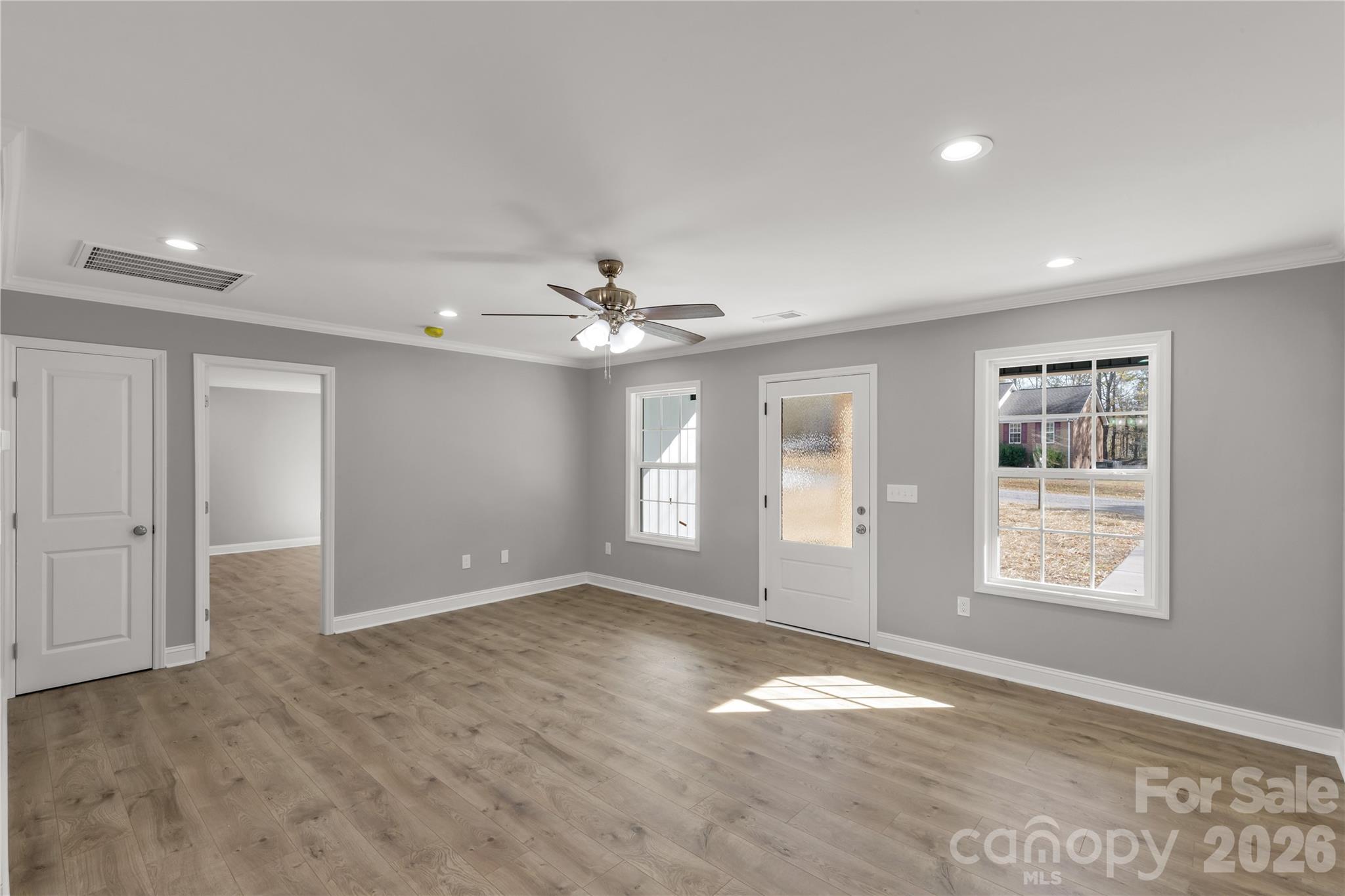 2166 Reeves Road Lancaster, SC 29720 - Photo 8 of 37 an empty room with windows and ceiling fan