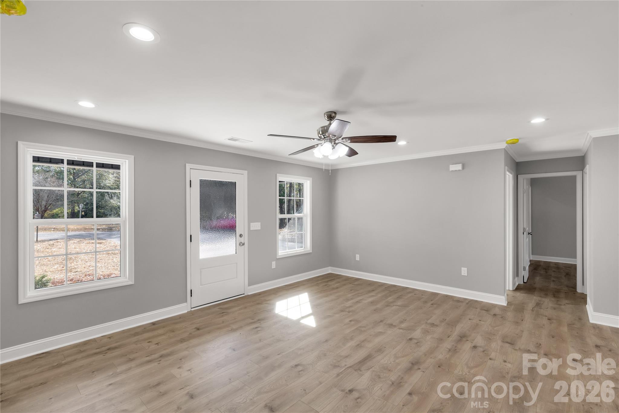 2166 Reeves Road Lancaster, SC 29720 - Photo 9 of 37 a view of an empty room with wooden floor and a window