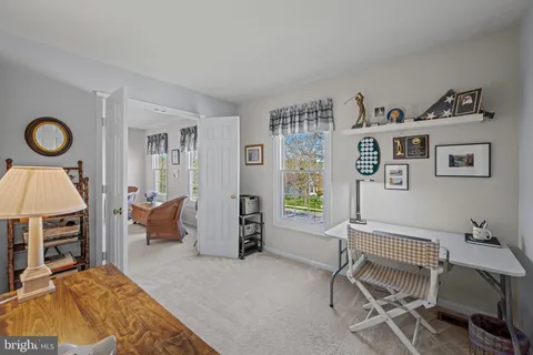a bedroom with a bed and a lamp on dresser