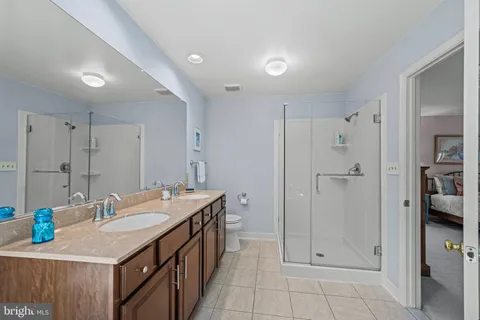 a bathroom with a tub a sink and mirror
