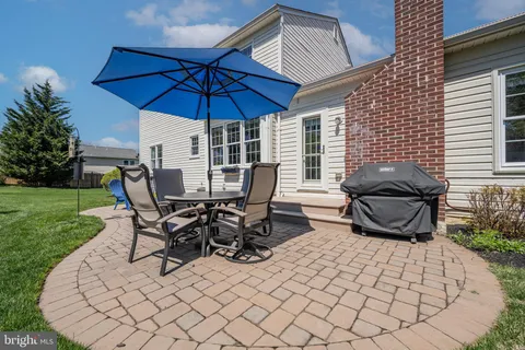 a patio with a table and chairs