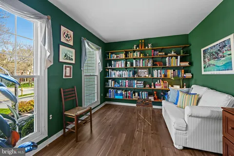 a living room with furniture and a book shelf