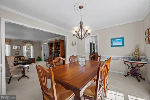 a view of a dining room with furniture and a chandelier