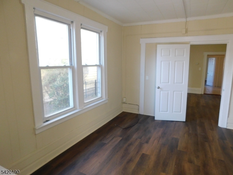 282 Renner Avenue, Unit 1 Newark, NJ 07112 - Photo 11 of 19 a view of an empty room with wooden floor and a window