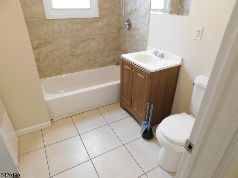 282 Renner Avenue, Unit 1 Newark, NJ 07112 - Photo 16 of 19 a bathroom with a sink toilet and shower