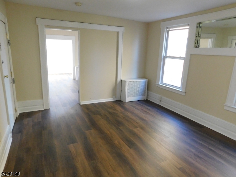 282 Renner Avenue, Unit 1 Newark, NJ 07112 - Photo 7 of 19 a view of a room with wooden floor and windows