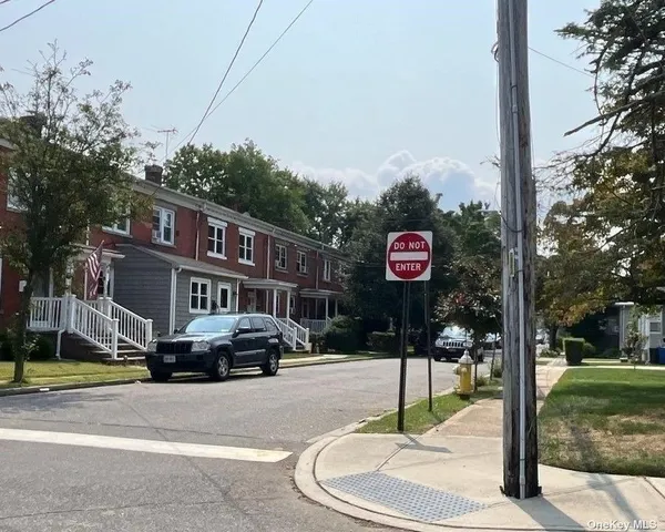 a street sign on a sidewalk next to a road