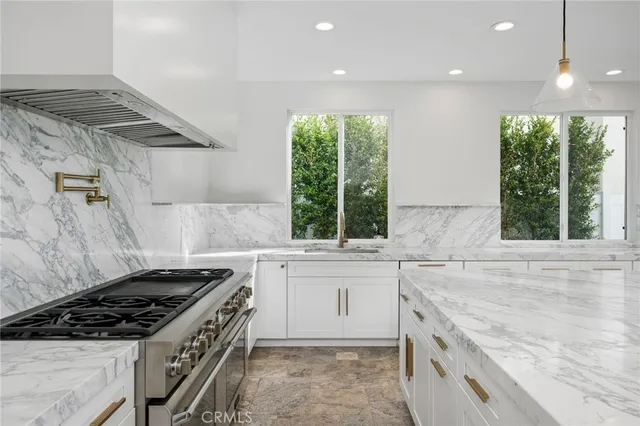 a kitchen that has a sink and a stove
