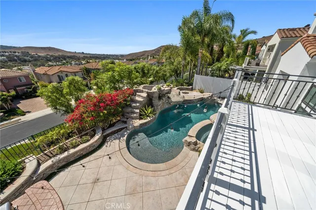 an aerial view of residential houses with outdoor space and parking