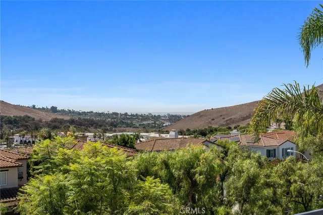 an aerial view of residential houses with outdoor space and ocean view