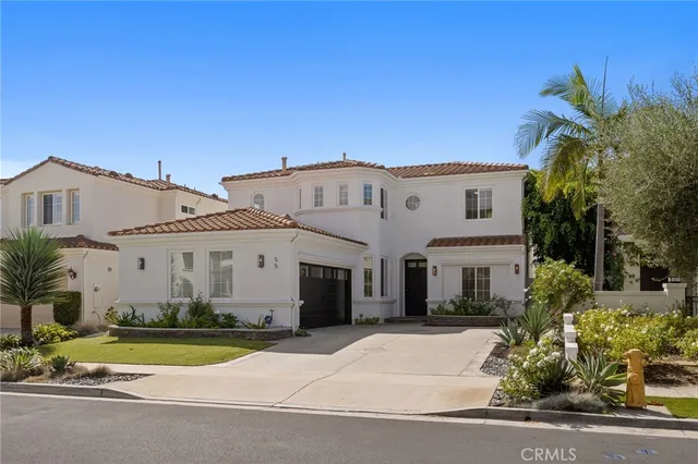 a view of white house with a yard and plants