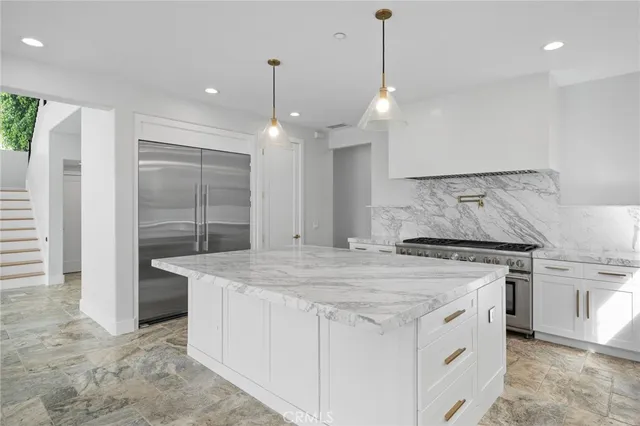 a kitchen with a stove a sink and a refrigerator