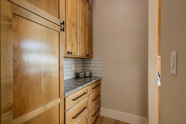 a kitchen with a stove and a granite counter tops