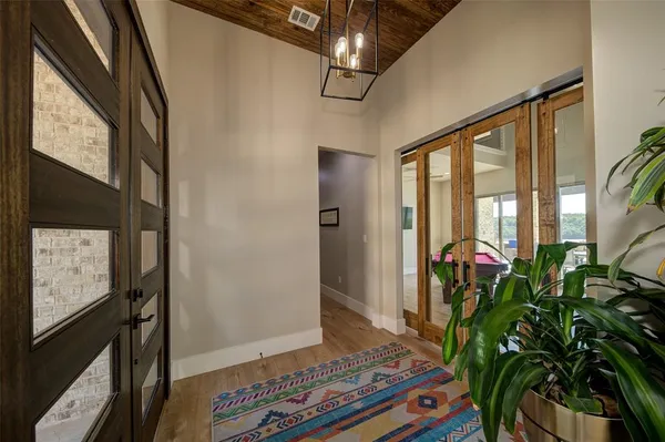 a living room with furniture a wooden floor and a large window