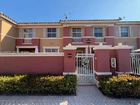 a view of a house with a yard and potted plants