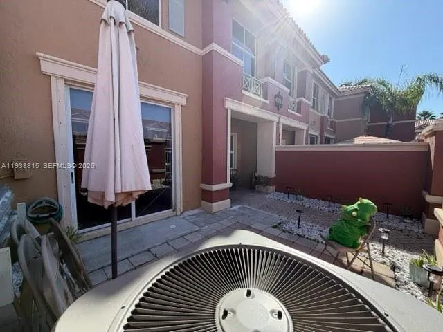 a front view of house with a garden