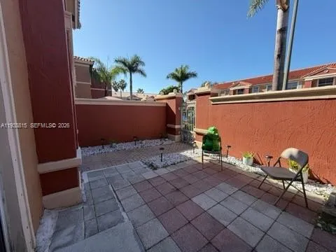 a view of a chairs and table in a backyard