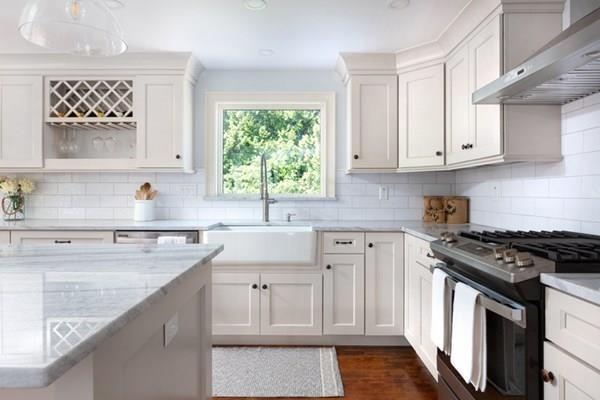 25 Magnolia Road Milton, MA 02186 - Photo 9 of 28 a kitchen with granite countertop a sink a stove and cabinets
