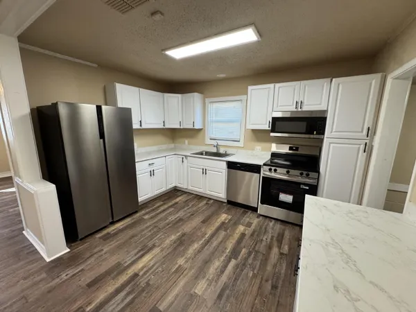 a kitchen with wooden cabinets and stainless steel appliances