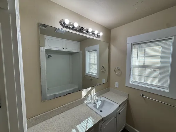 a bathroom with a double vanity sink and a mirror
