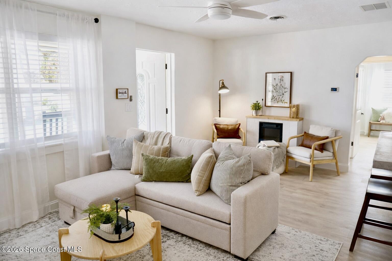 804 Oak Street Melbourne Beach, FL 32951 - Photo 1 of 51 a living room with furniture and a fireplace
