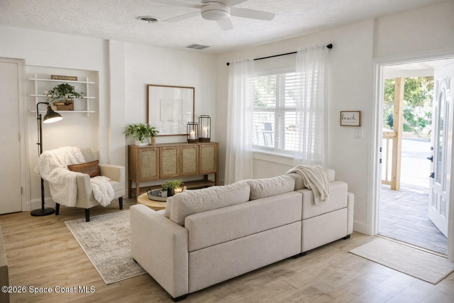804 Oak Street Melbourne Beach, FL 32951 - Photo 16 of 51 a living room with furniture and a large window