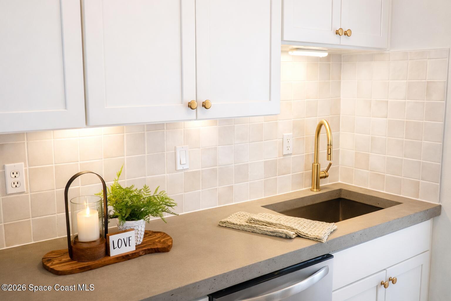 804 Oak Street Melbourne Beach, FL 32951 - Photo 20 of 51 a kitchen with a sink and a stove top oven