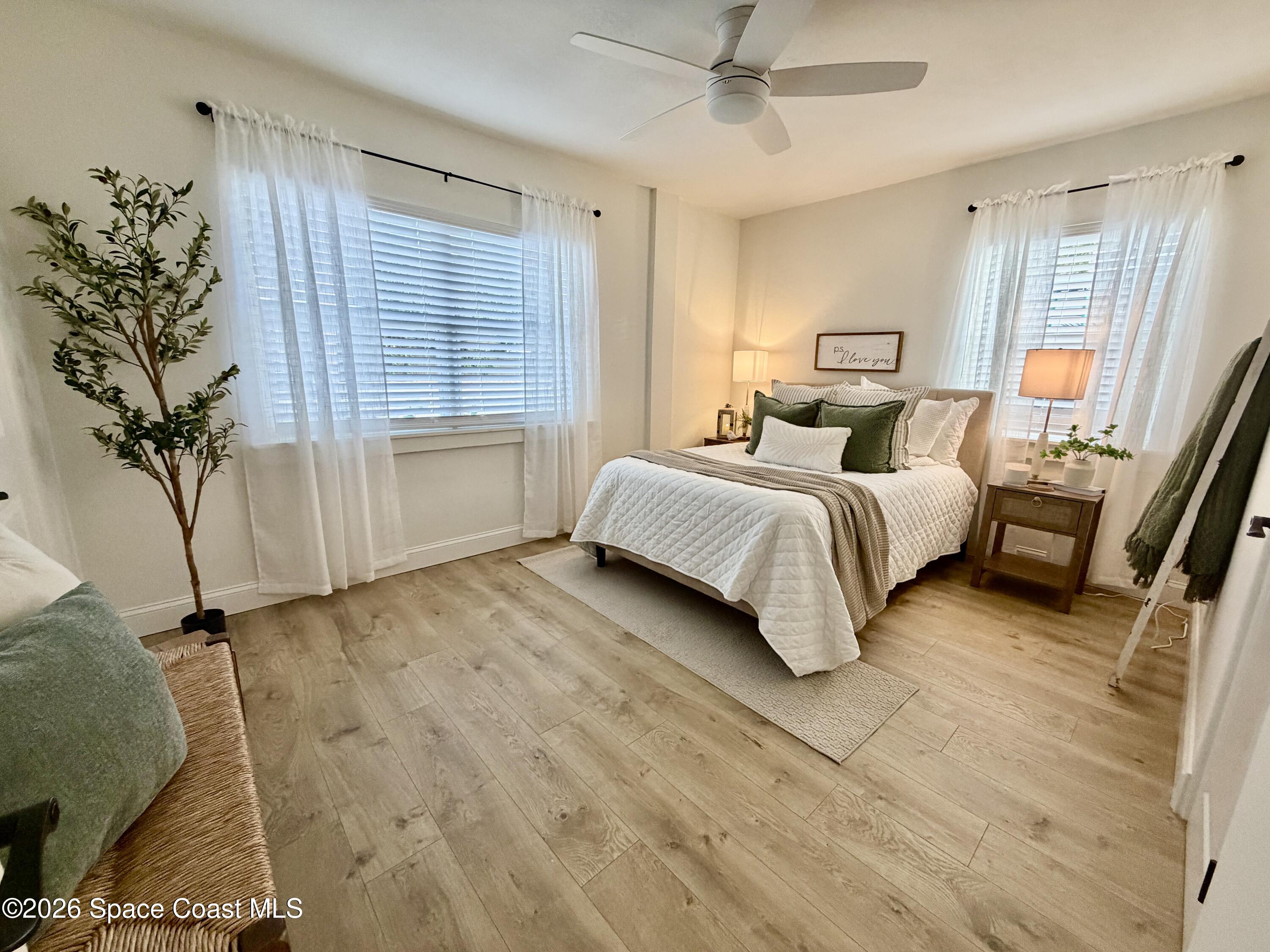 804 Oak Street Melbourne Beach, FL 32951 - Photo 25 of 51 a spacious bedroom with a bed and a potted plant