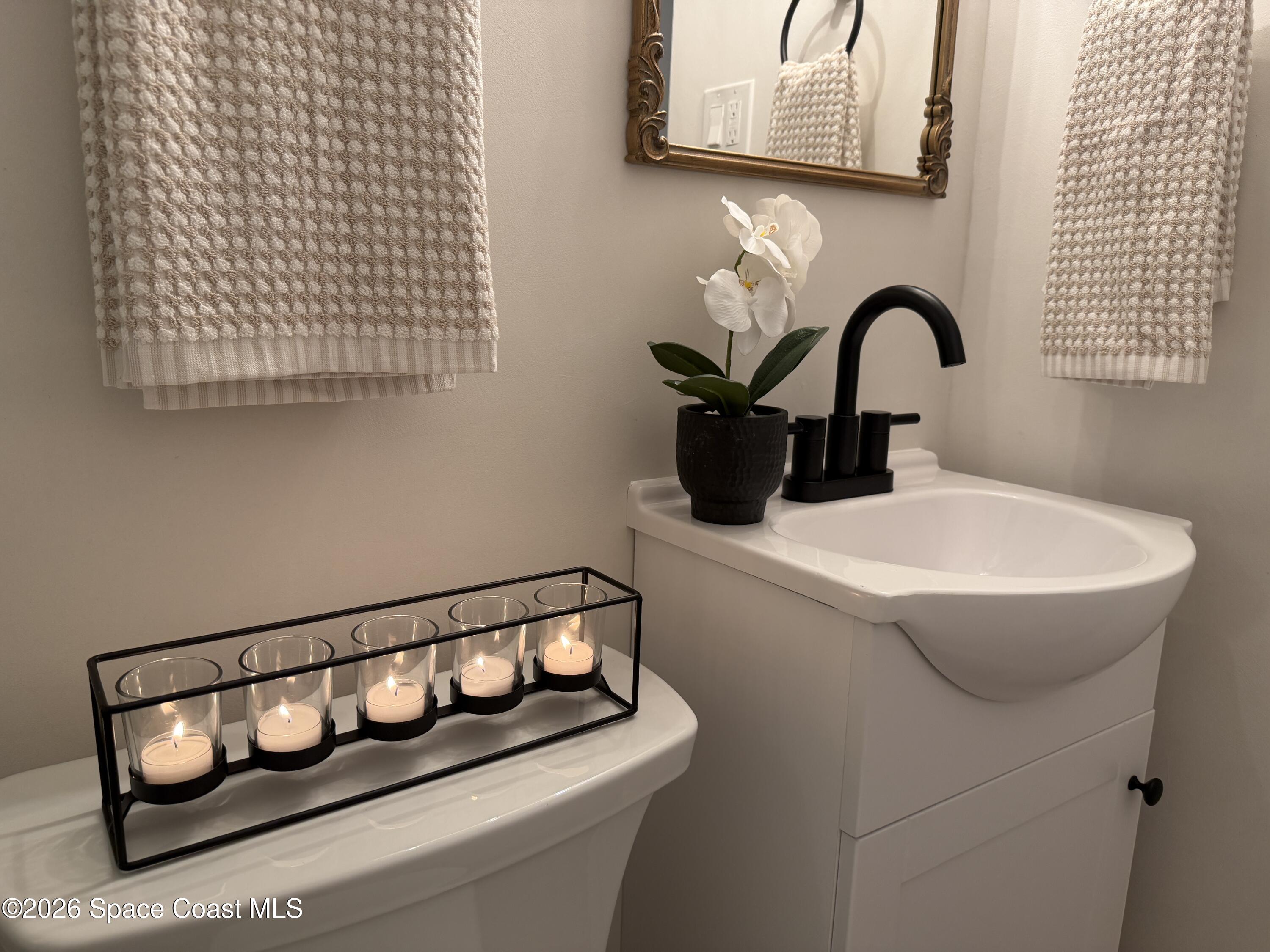 804 Oak Street Melbourne Beach, FL 32951 - Photo 26 of 51 a bathroom with a sink and a mirror