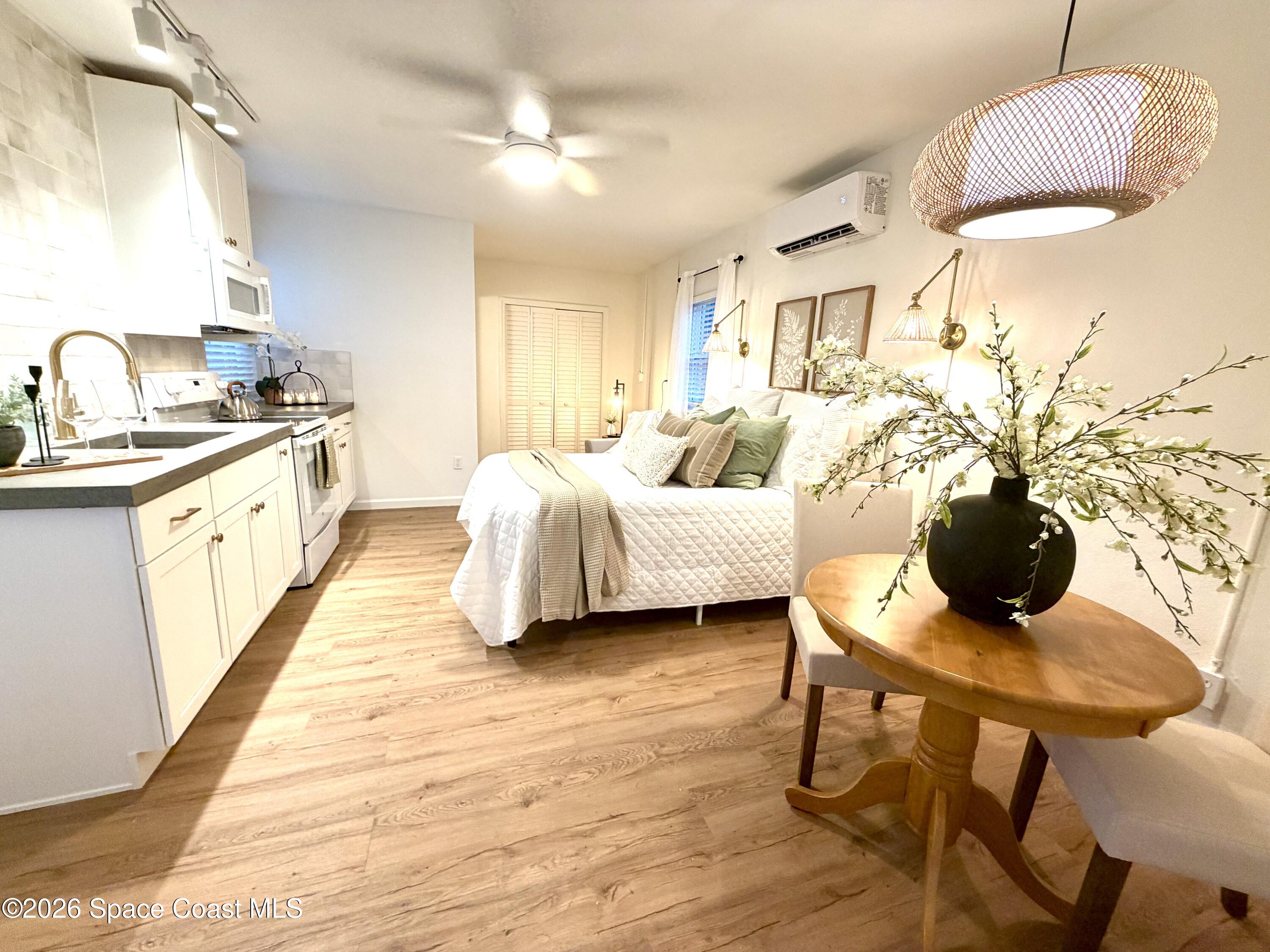 804 Oak Street Melbourne Beach, FL 32951 - Photo 40 of 51 a spacious bedroom with a bed and a chandelier