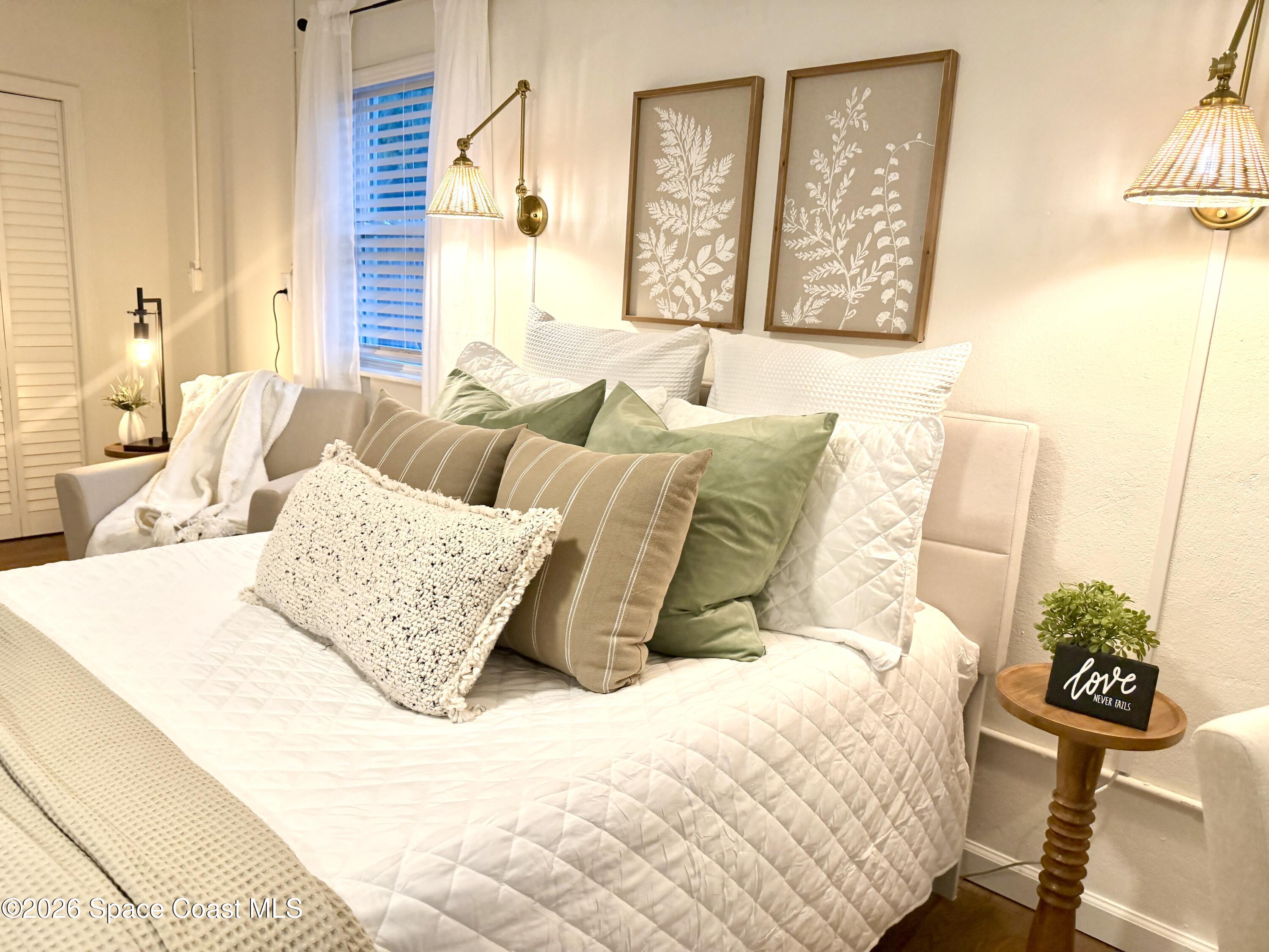 804 Oak Street Melbourne Beach, FL 32951 - Photo 42 of 51 a bedroom with a bed and wooden floor