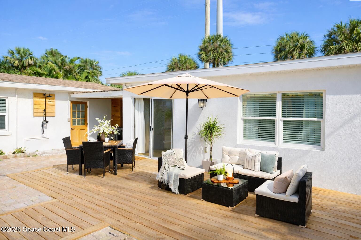 804 Oak Street Melbourne Beach, FL 32951 - Photo 47 of 51 a dining space with patio furniture and potted plants