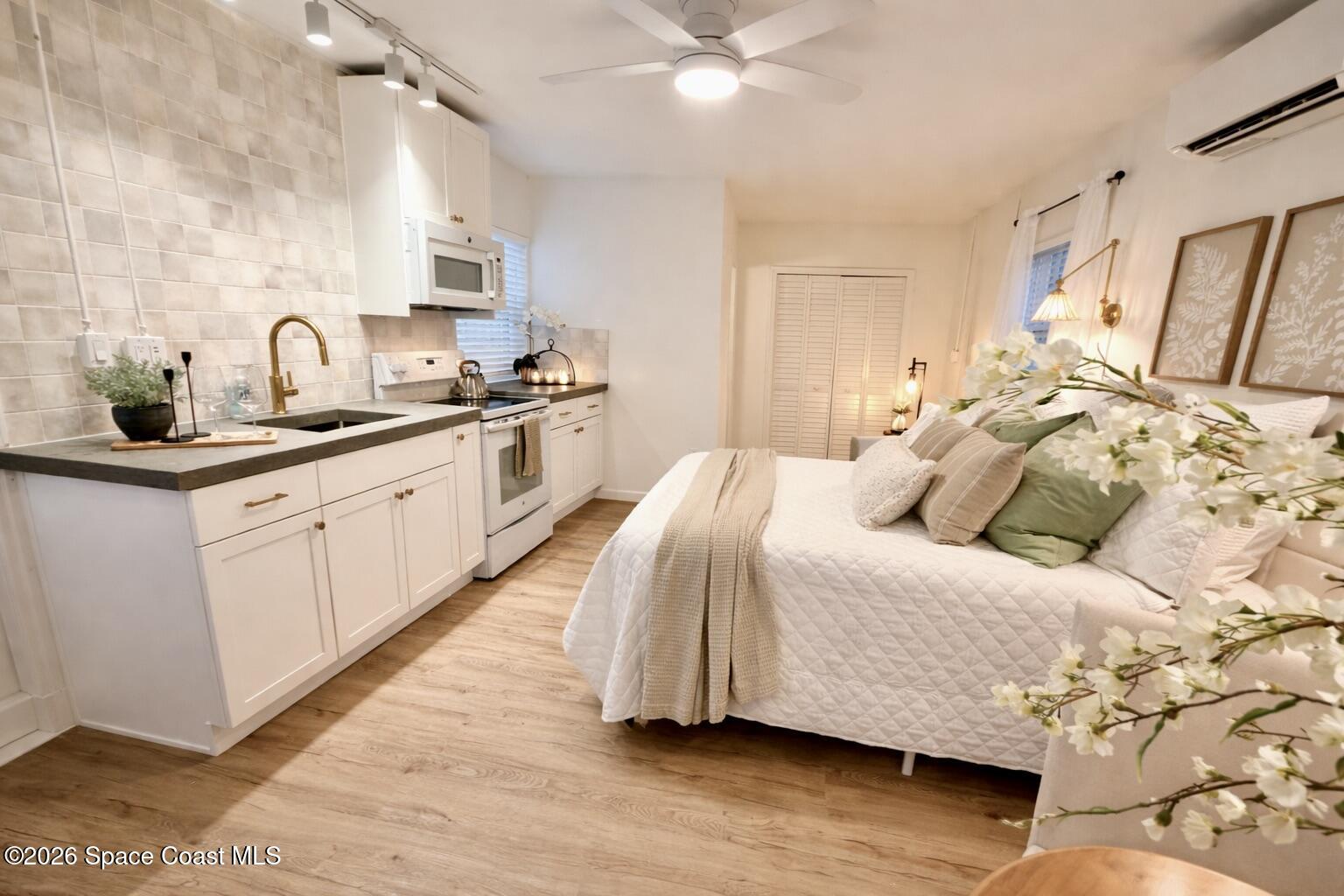 804 Oak Street Melbourne Beach, FL 32951 - Photo 10 of 51 a spacious bedroom with a bed and a cabinets