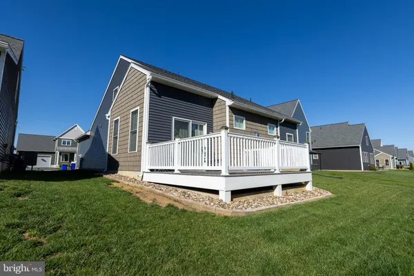 a wooden bench sitting in front of a house