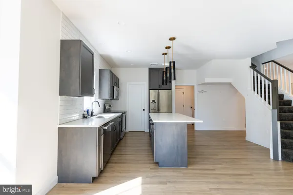 a kitchen with stainless steel appliances a sink stove and refrigerator