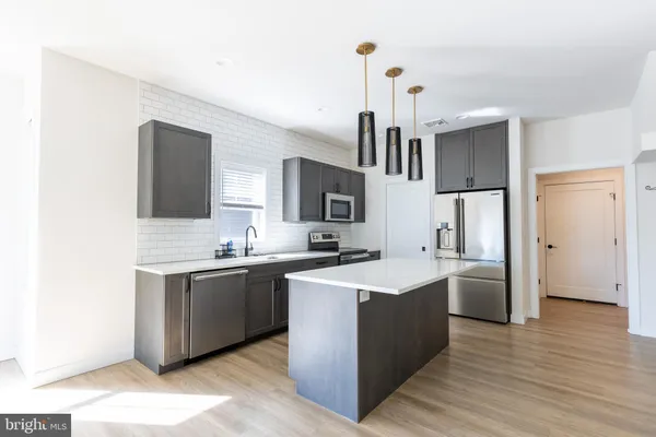a view interior of kitchen and dining room with wooden floor