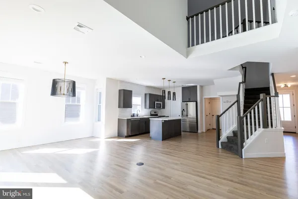 a kitchen with stainless steel appliances a sink a stove a microwave a sink and cabinets