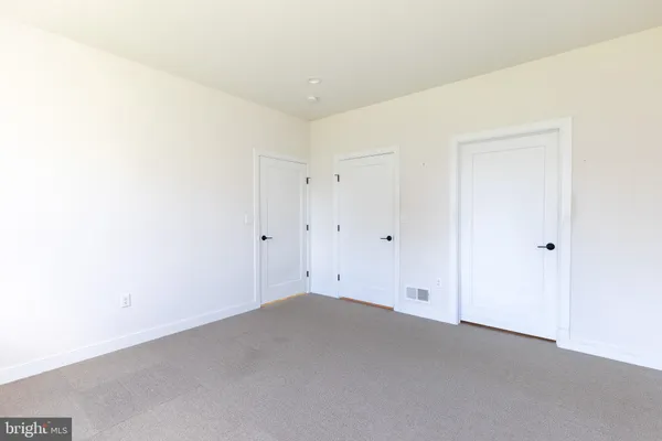 a bathroom with a toilet a sink a mirror and a shower