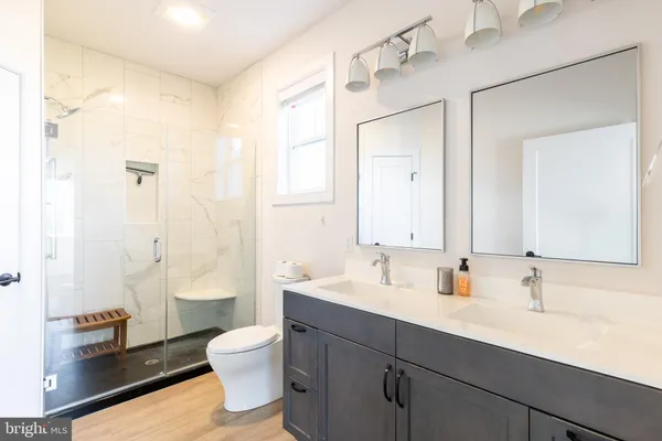a bathroom with a sink mirror and a bathtub