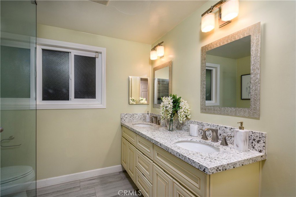 452 West Winnie Way Arcadia, CA 91007 - Photo 14 of 25 a bathroom with a granite countertop sink and a mirror