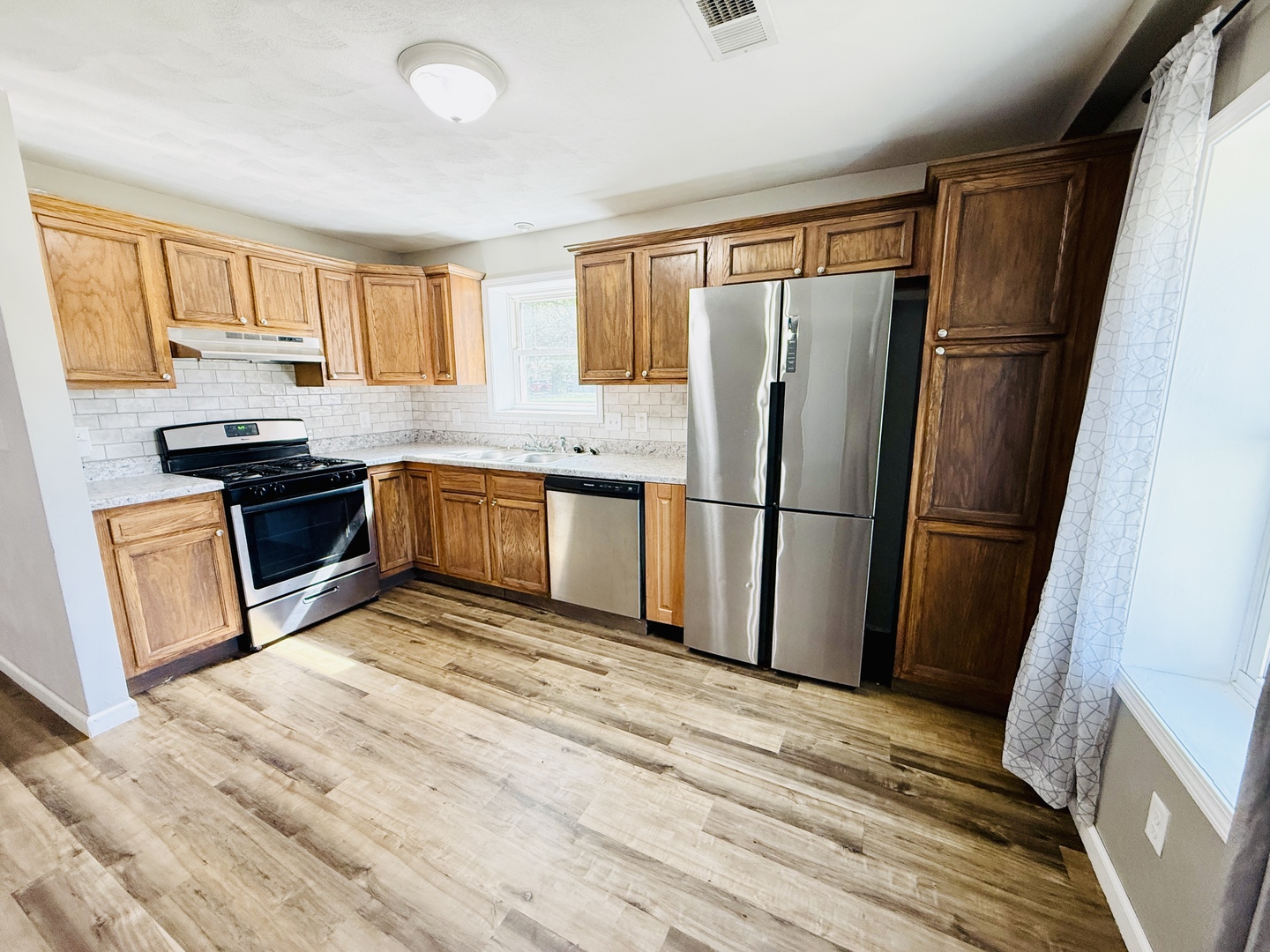 715 8th Street Colona, IL 61241 - Photo 3 of 14 a kitchen with stainless steel appliances granite countertop a refrigerator stove top oven and sink