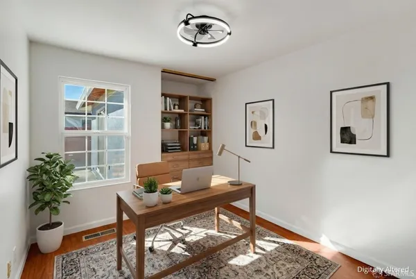 a living room with furniture and a potted plant