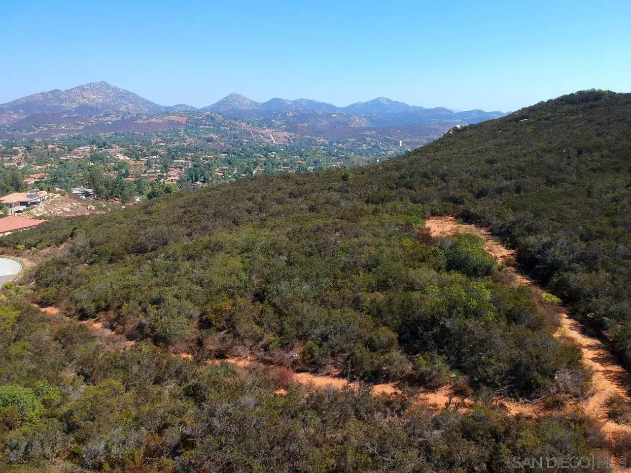 7 Del Poniente Road, Unit 7 Poway, CA 92064 - Photo 1 of 26 a view of a lush green hillside and a mountain