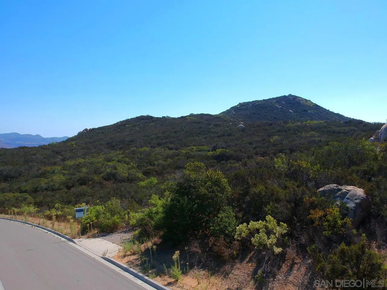 7 Del Poniente Road, Unit 7 Poway, CA 92064 - Photo 19 of 26 a view of a house with a mountain in the background